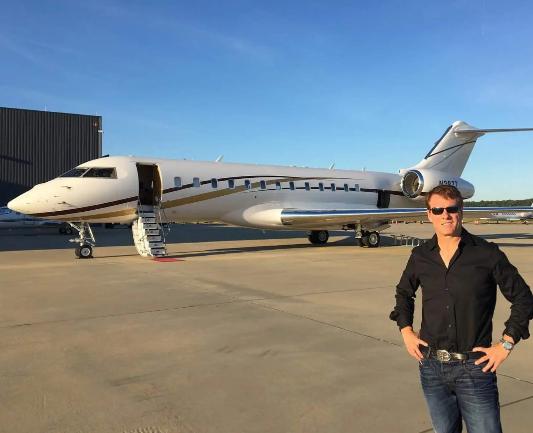 young saylor standing in front of a plane