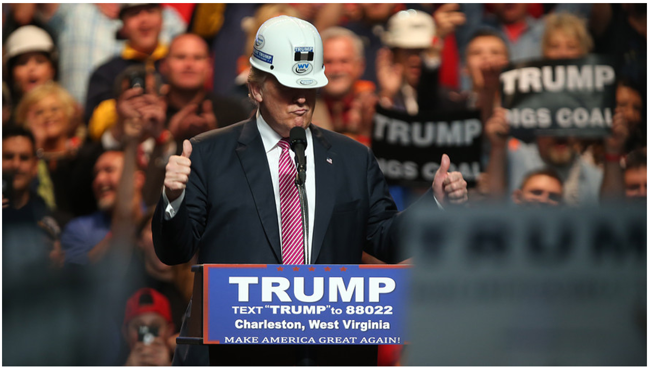 trump wearing a worker's helment at a rally